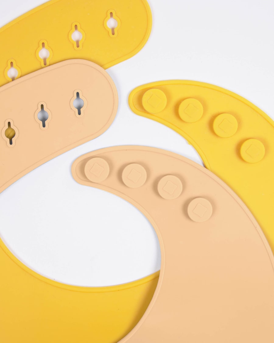 Epiphany set of 2 silicone bibs in brown and mustard