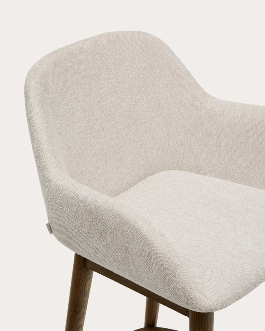 Konna stool in beige and solid ash wood legs in a dark finish, 65 cm